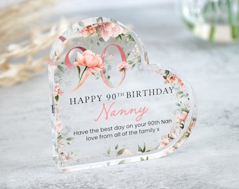 May include: A clear heart-shaped acrylic paperweight with a floral design and the text "HAPPY 90TH BIRTHDAY Nanny Have the best day on your 90th Nan love from all of the family x".