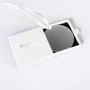 a white box with a white ribbon around it