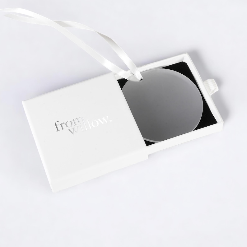 a white box with a white ribbon around it