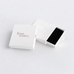 a white box with a black square inside of it