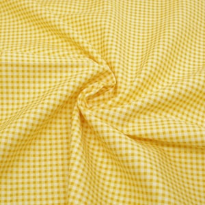 May include: Yellow and white gingham fabric with a small checkered pattern. The fabric is folded and wrinkled.