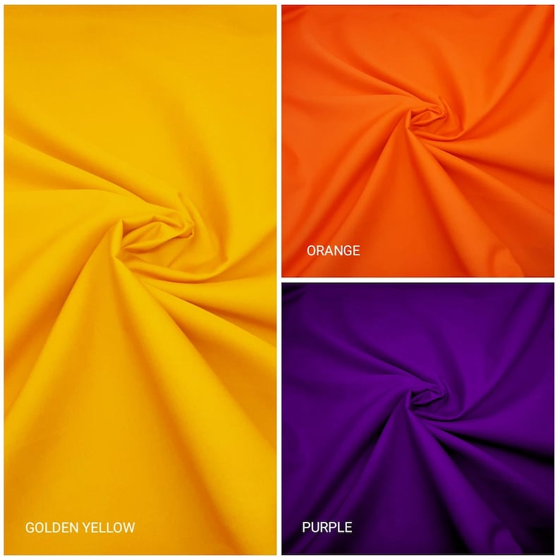 May include: Close-up of three fabric swatches in different colors: golden yellow, orange, and purple. The fabric is smooth and has a slight sheen.