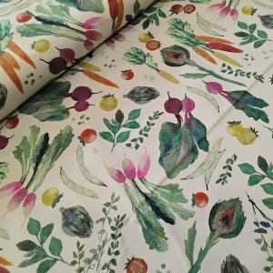 May include: A fabric featuring a watercolour design of vegetables. The pattern includes carrots, radishes, tomatoes, and artichokes in shades of green, red, yellow, and purple, set against a white background.