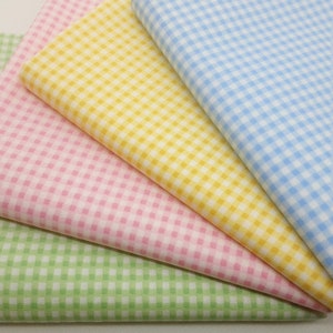 May include: Four fabric swatches in different colors: light green, pink, yellow, and light blue. Each swatch has a gingham pattern.