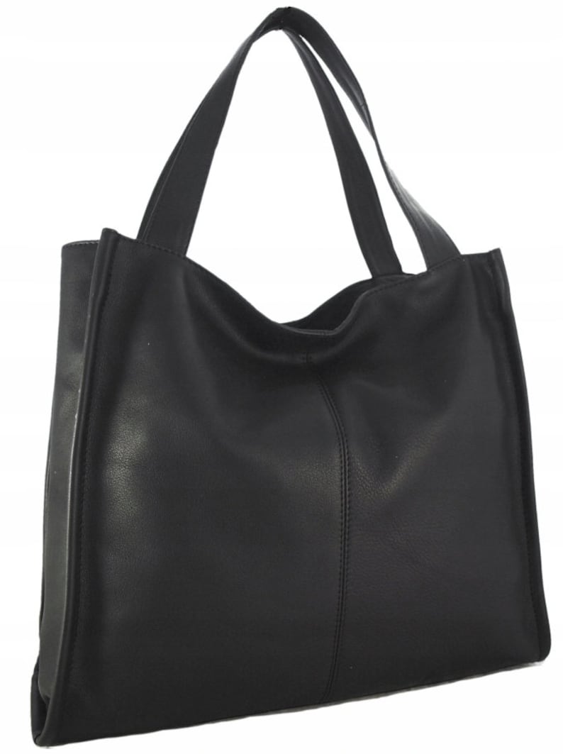 May include: A black tote bag with two handles. The bag is made of a smooth, matte material and features a vertical seam down the center. The handles are attached at the top of the bag and are the same color as the bag.