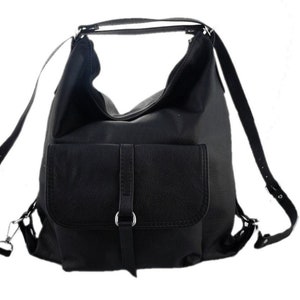 May include: Black leather backpack with a large main compartment and a front flap pocket. The bag has adjustable shoulder straps and a top handle. The hardware is silver-toned. The bag is designed to be worn as a backpack or carried as a shoulder bag.