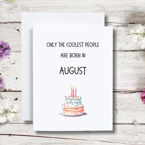 May include: White card with the text "Only the coolest people are born in August" and a watercolor illustration of a three-tiered birthday cake with candles.