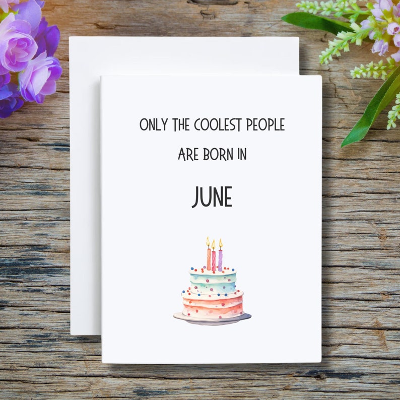 May include: White card with black text that reads "Only the coolest people are born in June". A watercolor illustration of a pink and blue layered cake with four lit candles is below the text.