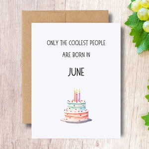 May include: A white card with the text "ONLY THE COOLEST PEOPLE ARE BORN IN JUNE" and a watercolor illustration of a three-tiered birthday cake with candles.