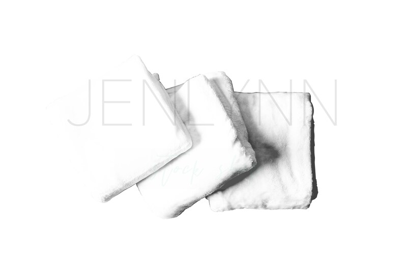 May include: Three white, fluffy, square-shaped pillows arranged on a white background.