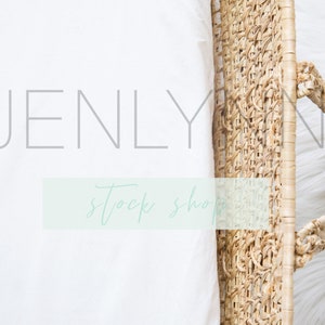 May include: A white sheet of fabric with the text "JENLY stock shop" on it. A woven basket with a handle is partially visible in the upper right corner of the image.