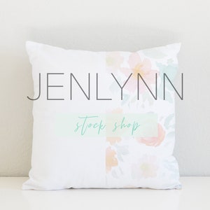 May include: White pillow with a floral design and the text "JENLYNN stock shop" printed on it.