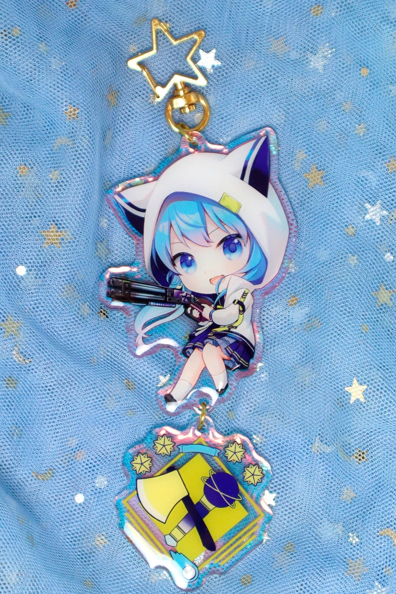 May include: A blue and white anime character keychain with a gun and a yellow and blue axe charm. The character has blue hair and is wearing a white hooded jacket with cat ears.