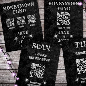 May include: Four black and white signs with a spooky Halloween theme. The signs have QR codes and text that reads "Honeymoon Fund", "Scan to view our wedding program", "Tip the bartender", and "Thank you from Jane & JC".