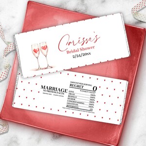 May include: Two chocolate bar wrappers with a bridal shower theme. One wrapper has the text "Corissa's Bridal Shower 2/24/20xx" and a watercolor illustration of two champagne flutes with hearts. The other wrapper has a "Marriage Nutrition Facts" label.
