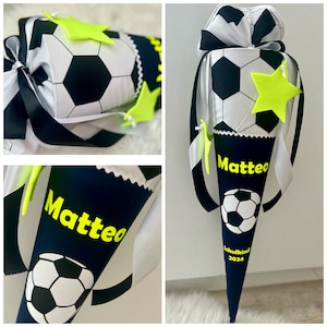 Könnte beinhalten: Ein blauer und weißer Schultüte mit einem Fußball-Design. Die Tüte hat einen gelben Stern und den Namen "Matteo" darauf geschrieben. Die Tüte trägt außerdem den Schriftzug "Schulkind 2024".