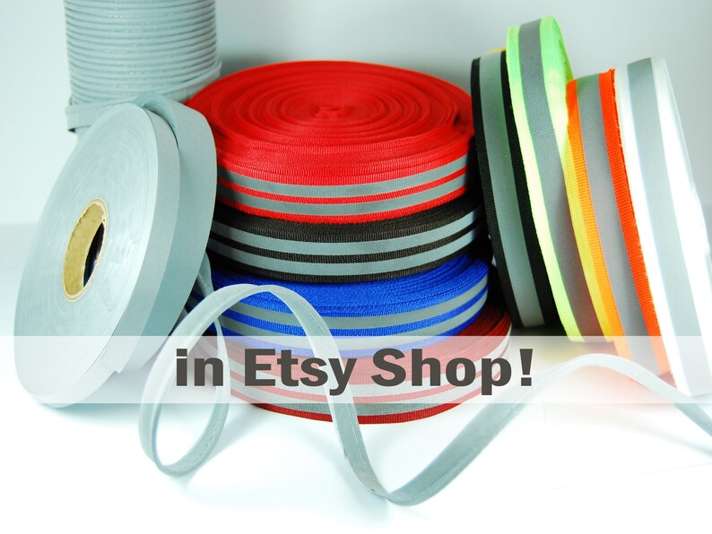May include: Assortment of reflective ribbon rolls in various colors, including red, blue, gray, orange, yellow, and green. The ribbon is available in an Etsy shop.