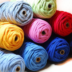 Könnte beinhalten: Eine Sammlung von bunten Baumwollseilschnüren in verschiedenen Blautönen, Gelb, Rosa, Grün, Rot und Marineblau.