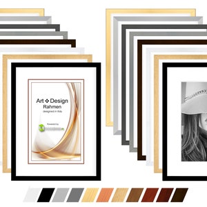May include: A set of 12 picture frames in various colors, including black, white, gray, brown, and wood tones. The frames are arranged in two rows of six, with the top row showing a frame with a gold abstract design and the bottom row showing a frame with a black and white photo of a woman wearing a hat. The frames are all the same size and have a simple, modern design.