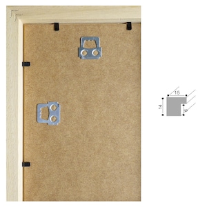 May include: A wooden picture frame with a brown cardboard backing. The frame has two metal hanging hooks on the back. The frame measures 15 inches by 14 inches.