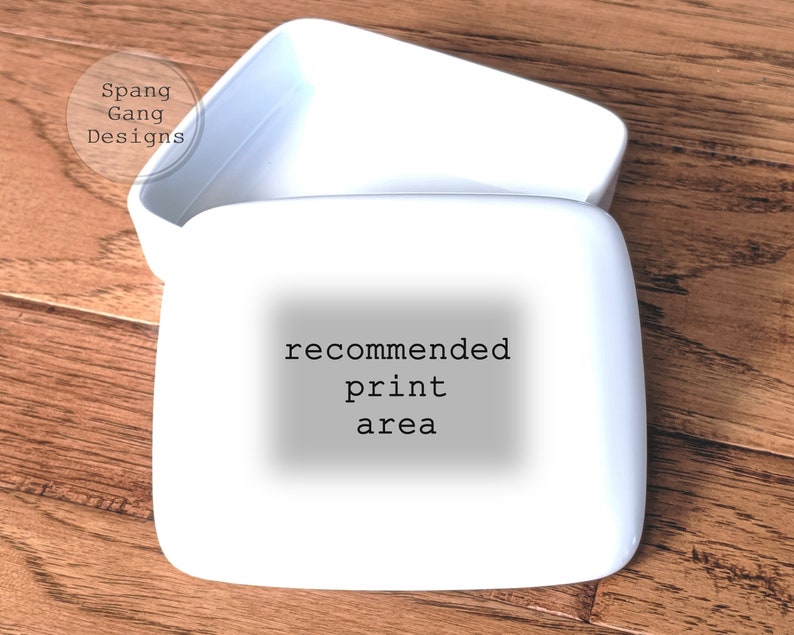 May include: White ceramic box with a lid. The box has the text "recommended print area" printed on the front.