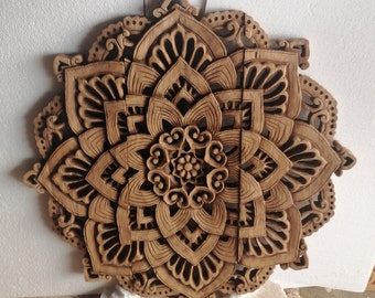May include: A detailed, wooden mandala wall art piece. The intricate design features a central floral motif surrounded by layered, carved petals and decorative elements. The natural wood color and detailed carving create a striking visual effect, suitable for home decor.