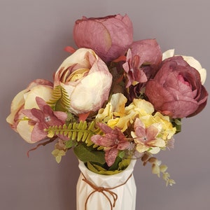 Vintage bouquet, decoration aged artificial plant with roses purple / cream
