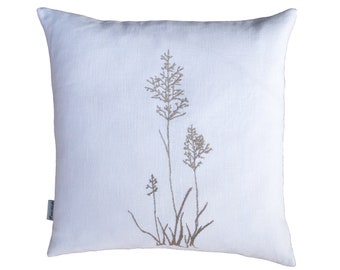 May include: White linen pillow with a brown embroidered design of tall grass.