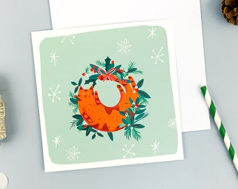 Greeting card, illustration of a cat with Christmas wreath