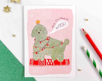 Greeting Card, Christmas Dog sitting in gift wrapping. Postcard for the end of year celebrations