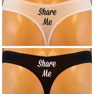 May include: Two pairs of underwear, one white and one black, with the text "Share Me" printed on the back.