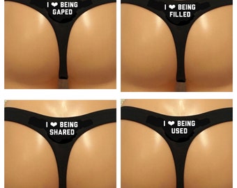 I Love Being Shared, Filled, Used. Design is printed on the back of the thong.