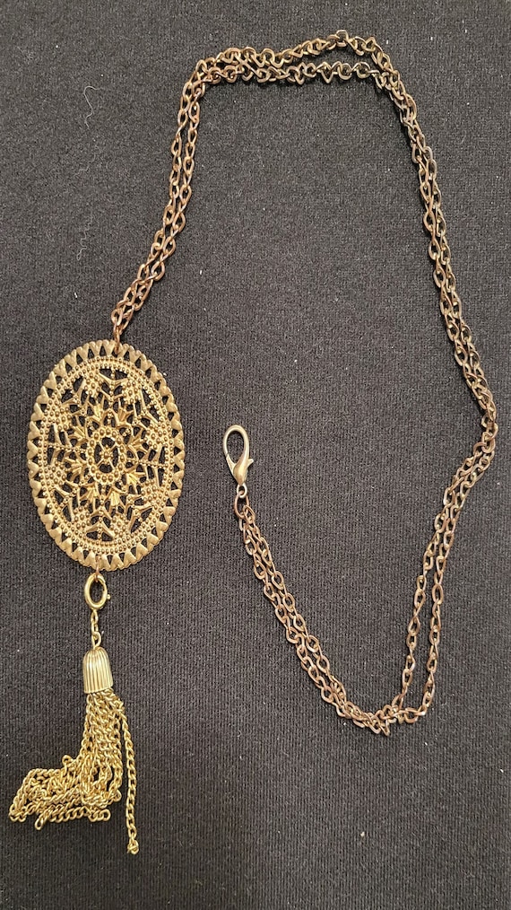 Vintage Fillagree round medallion with tassel.