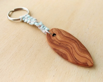 small surfboard keychain, lovingly handcrafted from wood, with macrame cord