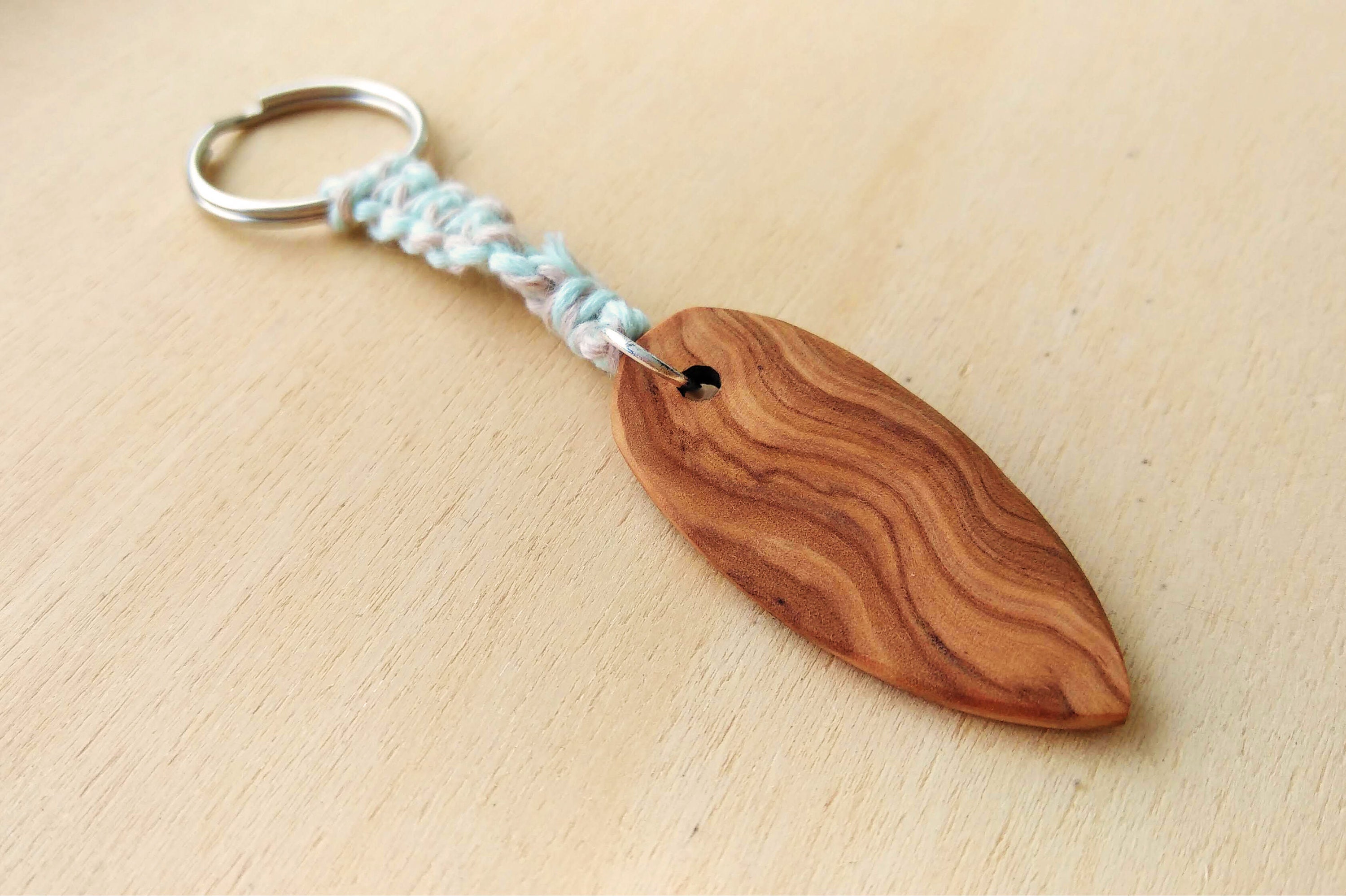 small surfboard keychain, lovingly handcrafted from wood, with macrame cord