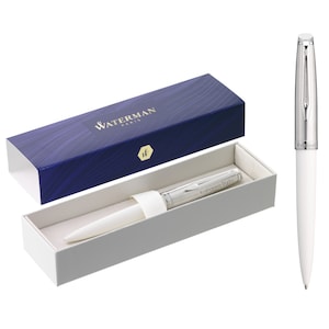 May include: A white Waterman Paris pen with silver accents in a white box with a blue and silver lid. The pen has the name "Katharina Duda" engraved on it.