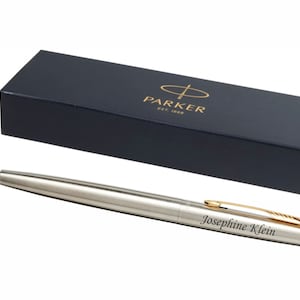 May include: A silver Parker fountain pen with a gold trim and a black ink cartridge. The pen is engraved with the name "Josephine Klein". The pen is in a black box with the Parker logo.