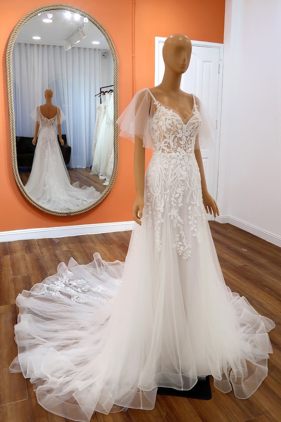 navy blue dress for baby girl Modified A-Line Lace Wedding Dress with Detachable Flutter Sleeves, Flower Appliqué, Intricate Beading, Dramatic Train for Outdoor Wedding