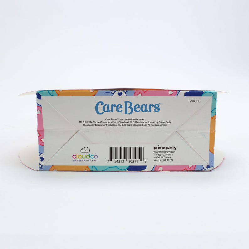 May include: Care Bears box with a colorful design featuring the Care Bears characters. The box is labeled "Care Bears" and includes the text "TM & &copy; 2004 Those Characters From Cleveland, LLC Used under license by Prime Party Cloudco Entertainment with logos. TM & &copy; 2004 Cloudco, LLC. All rights reserved."