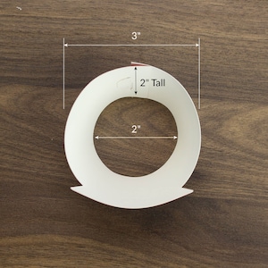 May include: White paper craft ring with a 2 inch diameter and 3 inch height. The ring is made of paper and is designed to be used as a craft project.