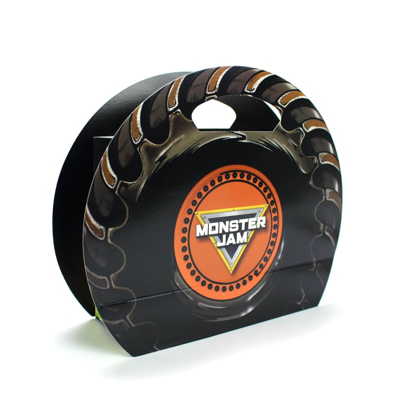 May include: Black and orange Monster Jam themed cardboard carrying case with a handle. The case has a tire tread design and the Monster Jam logo.
