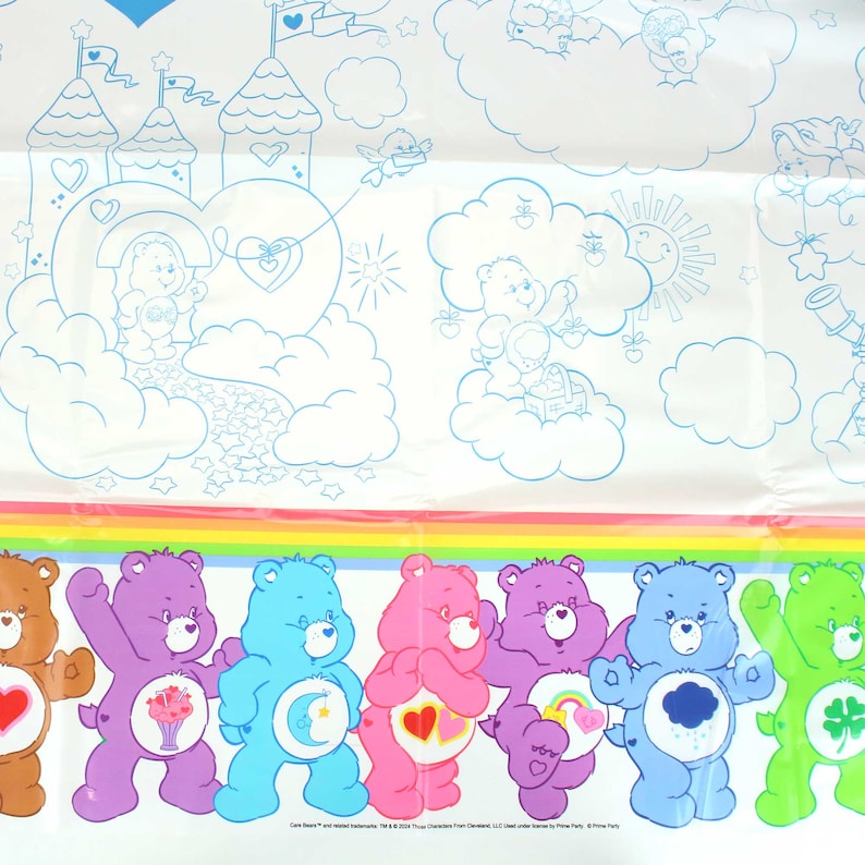 May include: A white tablecloth with a rainbow border and a scene of Care Bears in a cloud-filled sky. The Care Bears are lined up at the bottom of the tablecloth, each with their signature symbol and colors. The text "Care Bears" and "and related trademarks TM & &copy; 2004 Those Characters From Cleveland LLC. Licensed under license to Prima Party"