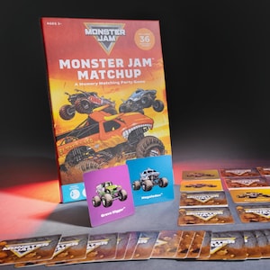 May include: A Monster Jam Matchup memory matching party game box featuring monster truck illustrations and the text "Monster Jam Matchup". Includes cards with monster truck graphics, such as Grave Digger and Megalodon.