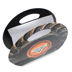 May include: A black and orange Monster Jam party favor box with a tire tread design and a handle. The box is made of cardboard and has a white interior.