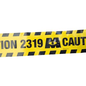 May include: Yellow caution tape with black diagonal stripes. The tape features the text "ION 2319 CAUT" and a graphic of an eye. The tape is against a white background.