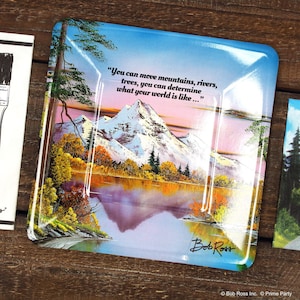 Pode incluir: Uma bandeja de cer&acirc;mica azul e branca com uma pintura de uma cena de montanha e uma cita&ccedil;&atilde;o de Bob Ross: "Voc&ecirc; pode mover montanhas, rios, &aacute;rvores, voc&ecirc; pode determinar como &eacute; o seu mundo..."