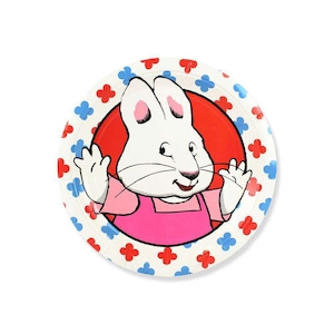 May include: Round paper plate featuring a cartoon rabbit character with a pink shirt and a red background. The plate has a white border with red and blue floral designs. The rabbit is smiling and waving.