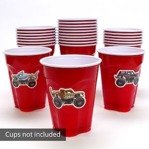 May include: Red plastic cups with white rims, some stacked and some with monster truck stickers. The image includes the text "Cups not included".