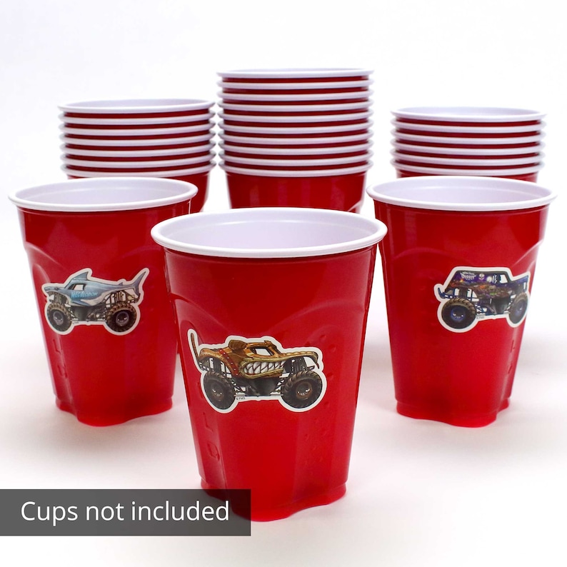May include: Red plastic cups with white rims, some stacked and some with monster truck stickers. The image includes the text "Cups not included".