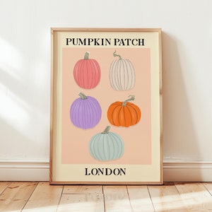 May include: A poster with the text "Pumpkin Patch London" in black lettering on a peach background. Five pumpkins are arranged in a grid pattern, with colours including pink, white, purple, orange, and blue.